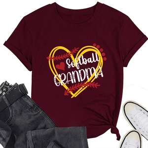 Flat lay of maroon Softball GRANDMA t-shirt styled with denim shorts and sneakers