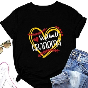Flat lay of Softball Grandma black t-shirt with heart graphic, sneakers and sunglasses