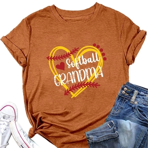 Flat lay of an orange Softball Grandma T-shirt with denim shorts and canvas sneakers