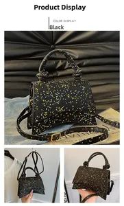 Detail of black glitter hourglass bag with colorful star patterns and knotted handle