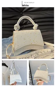 White glitter hourglass bag with unique knotted handle and gold metal hardware detail