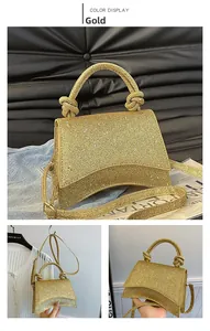 Detail view of gold glitter hourglass handbag with unique knotted handle and strap