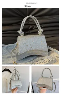 Detail of silver sequin handbag with knot handle and adjustable shoulder strap