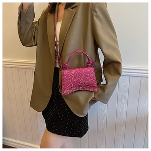 Detail of glitter pink hourglass handbag showing the knot handle and adjustable strap