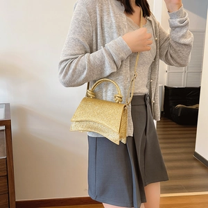 Golden sequin crescent handbag with round handle and detachable shoulder strap