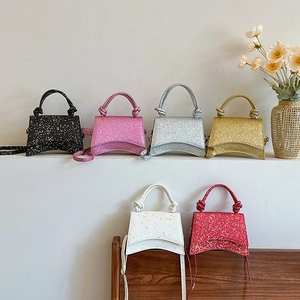 Group of six glitter hourglass handbags in multiple colors with knot handles and shoulder straps