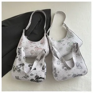 Collection of butterfly print underarm bags in pink, green, black and purple tones