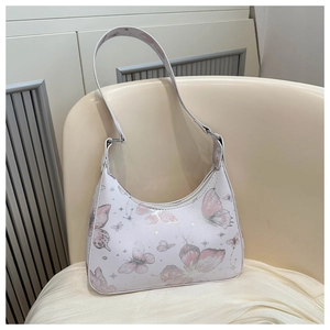 Detail of white hobo bag showing pink butterfly patterns and fine PU leather texture