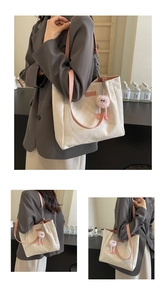 Detail of checkered tote bag with pink straps and plush charm in various perspectives
