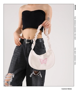 Detail of off-white pleated shoulder bag with pink butterfly embroidery and cloud strap