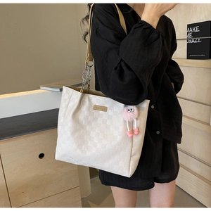 White checkered tote bag with metal chain strap and pink fuzzy charm for women