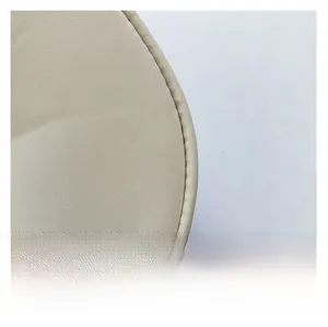 Close-up of beige woven fabric detail with precision stitching on a semi-round saddle bag