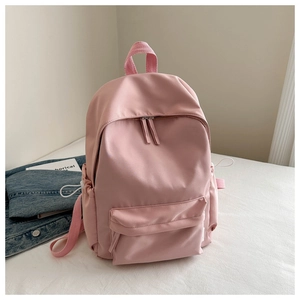 Detailed view of pink oxford backpack with durable metal zippers and side toggle pockets