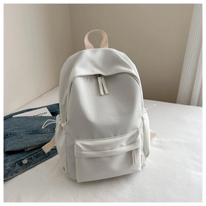 Detail view of the white oxford fabric backpack with side drawstring pockets and top handle