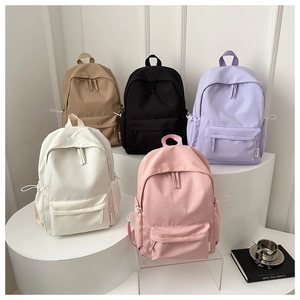 Five assorted minimalist high-capacity campus backpacks in a tiered lifestyle display