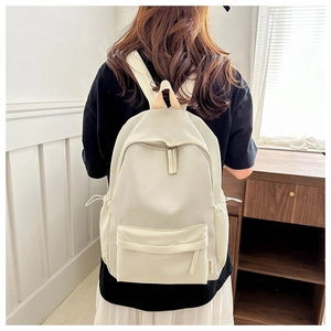 Detail of off-white Harajuku style backpack showing multiple pockets and fashion label