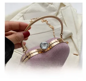 Detailed macro view of the lavender glitter evening bag with gold ring handle and diamond clasp