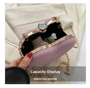 Pink sequin evening clutch featuring golden metal frame and large rhinestone clasp detail