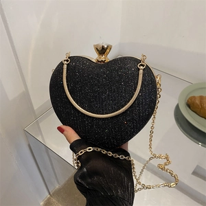 Sparkly black heart evening clutch bag with gold frame, jewel clasp and chain strap