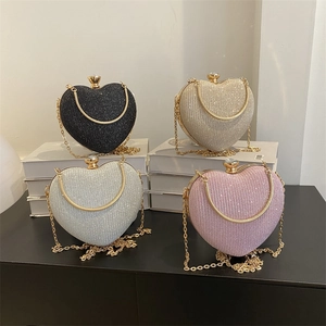 Elegant heart-shaped evening clutch bags in glitter finishes with gold chain straps
