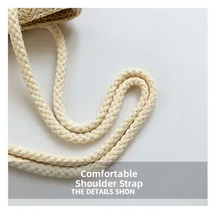 Detail view of woven cotton rope shoulder straps on a summer straw tote beach bag