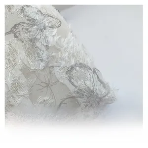 Detail of premium textured fabric with butterfly print and feather-like fringe tactile finish