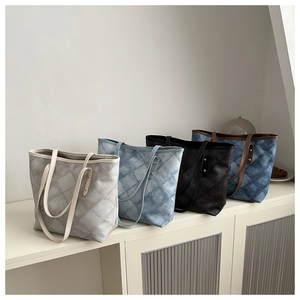 Detailed view of four quilted tote bags in various colors with elegant diamond stitching
