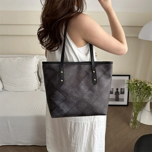Minimalist large tote bag with vintage check pattern and golden rivet details on shoulder strap