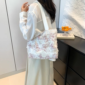 White canvas tote bag with purple butterfly embroidery and spacious shoulder strap