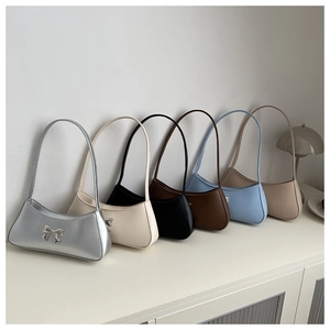 Selection of baguette shoulder bags in diverse colors like silver, blue, and black