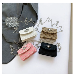 Detailed flat lay of four mini chain bags in white pink tan and black with M patterns