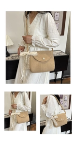 Detail of beige straw crossbody bag featuring pearl buckle and white lace bow decoration