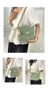 Detail of green knit crossbody bag with pearl buckle and cream lace bow accents