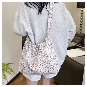 Floral print canvas hobo bag with drawstring closure and adjustable wide strap