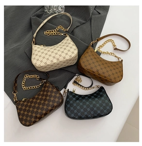 Detail of four rhombic pattern shoulder bags in beige, tan, brown and black with gold chains