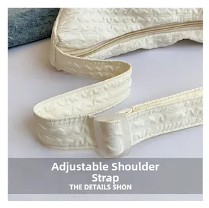 Detail of adjustable shoulder strap with frosted buckle on pleated dumpling bag