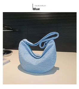 Detailed close-up of sky blue pleated dumpling bag with textured bubble fabric
