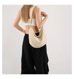 Chic cream beige dumpling bag featuring woven texture and crescent hobo silhouette