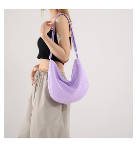 Detail shot of lavender bubble texture fabric on a crescent shoulder bag for women