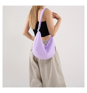 Detailed macro view of light purple bubble textured fabric on a hobo shoulder bag