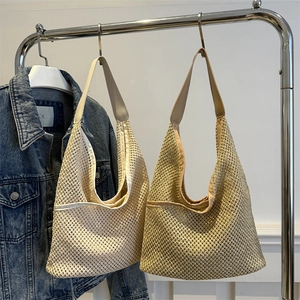 Minimalist straw woven tote bags in beige and light brown with wide leather straps for summer