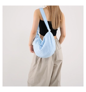 Detail view of light blue waffle texture fabric on a large hobo crossbody bag for women