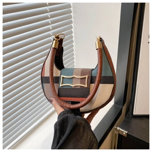 Detail of multi-color geometric pattern crescent bag with golden buckle and leather handle