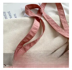 Detail of pink Oxford tote bag straps and texture with a premium minimalist aesthetic