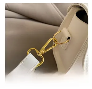 Detail of the high-quality gold swivel hook and stitching on the white leather handbag