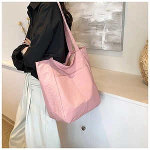 Pink tote bag detail showing large front pocket and comfortable wide shoulder strap