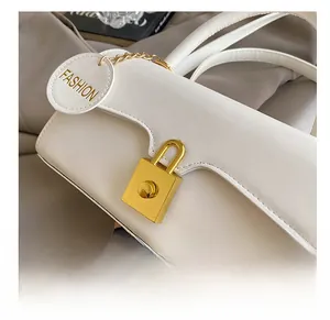 Detailed close-up of premium cream white PU leather bag with golden hardware buckle