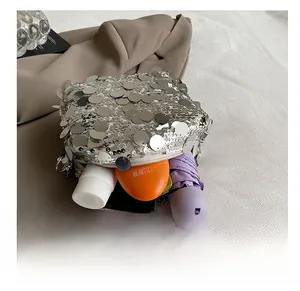 Detailed interior view of silver sequin shoulder bag showing storage for daily essentials