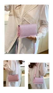 Detailansichten der glitzernden rosa Umhängetasche mit Trageriemen und goldener Hardware