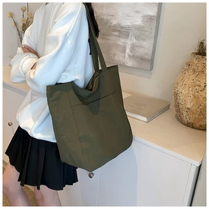 Detail of a large olive green waterproof tote bag made of durable oxford fabric material